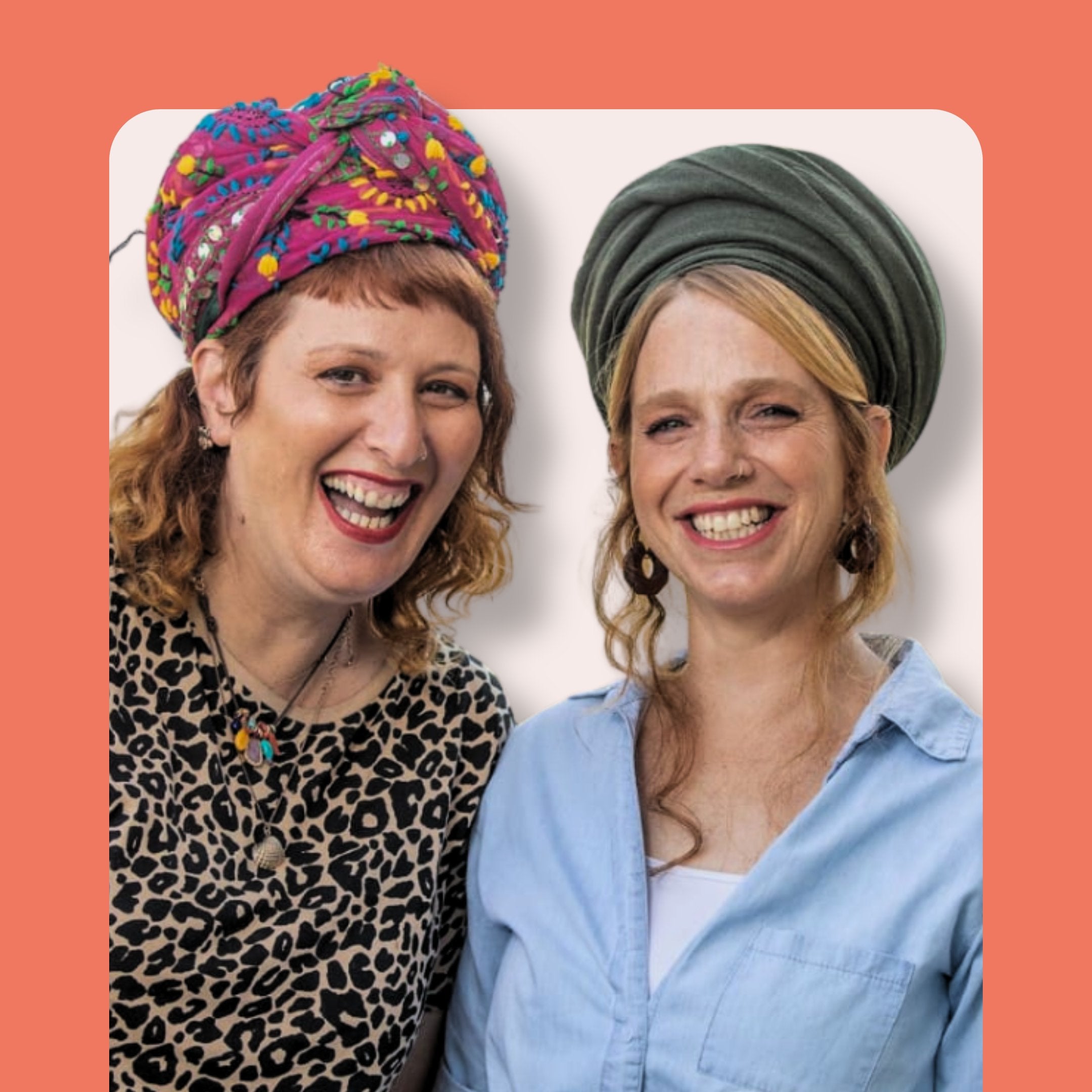 Two smiling women with headwraps, one in a colorful patterned turban and leopard print top, the other in a green headwrap and light blue shirt, standing in front of a peach background.