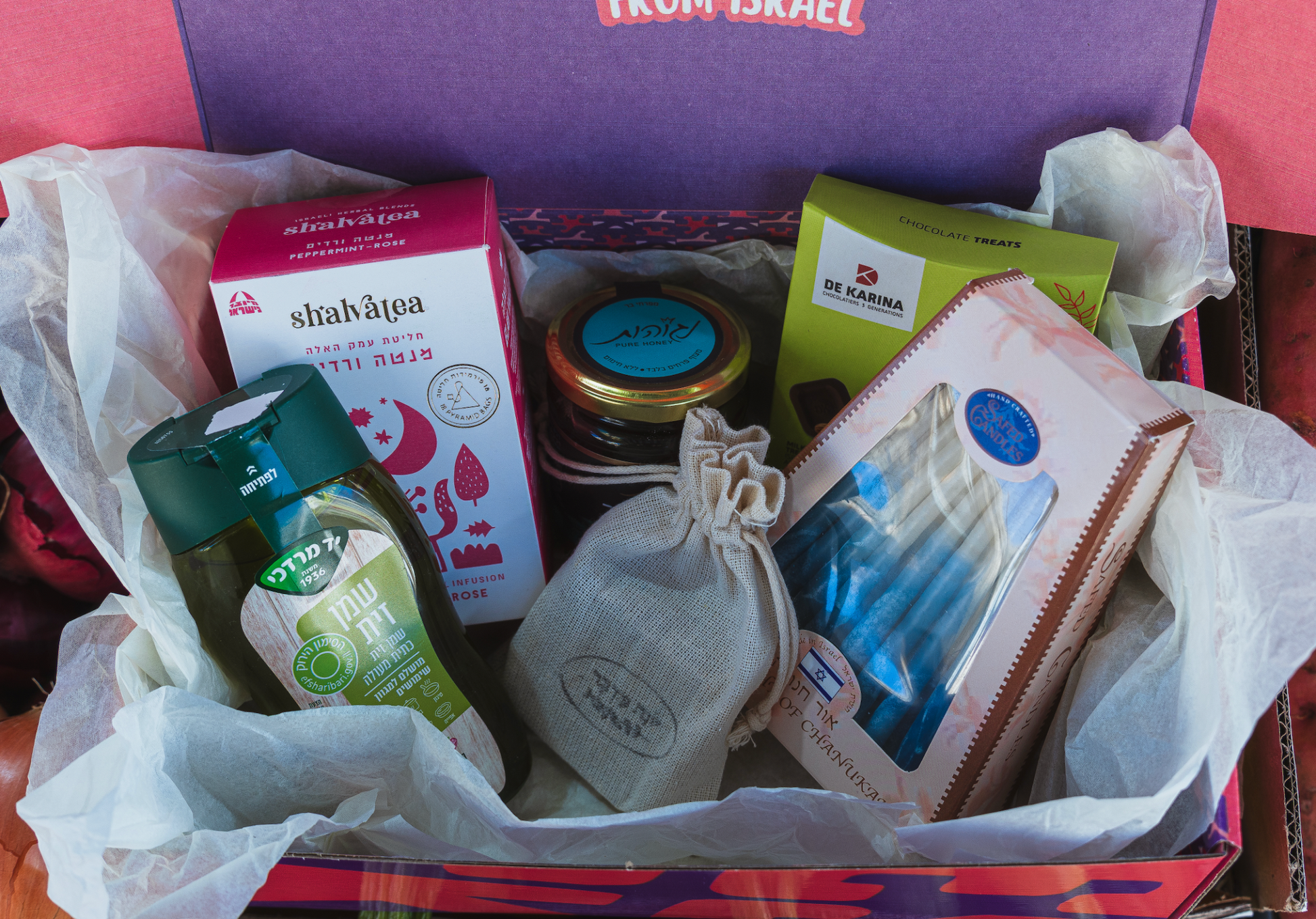 Chanukah Gift Box with Israeli olive oil, lavender soap, honey, chamomile tea, artisanal chocolate, and Hanukkah candles in a curated festive package