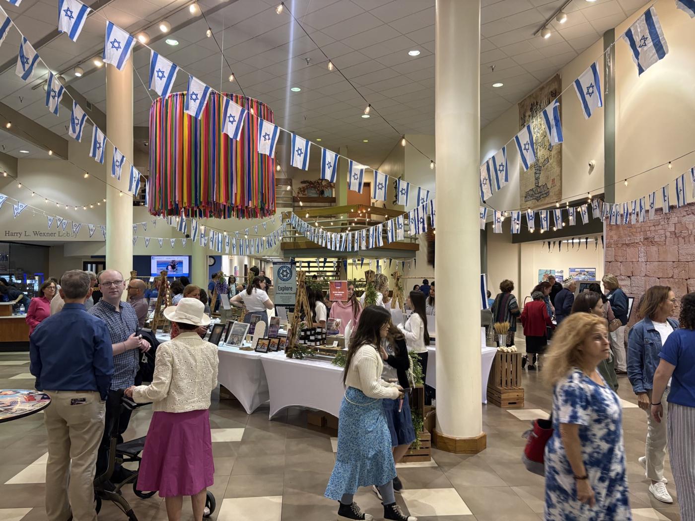 Visitors discovering Israeli small businesses at an ESEK marketplace