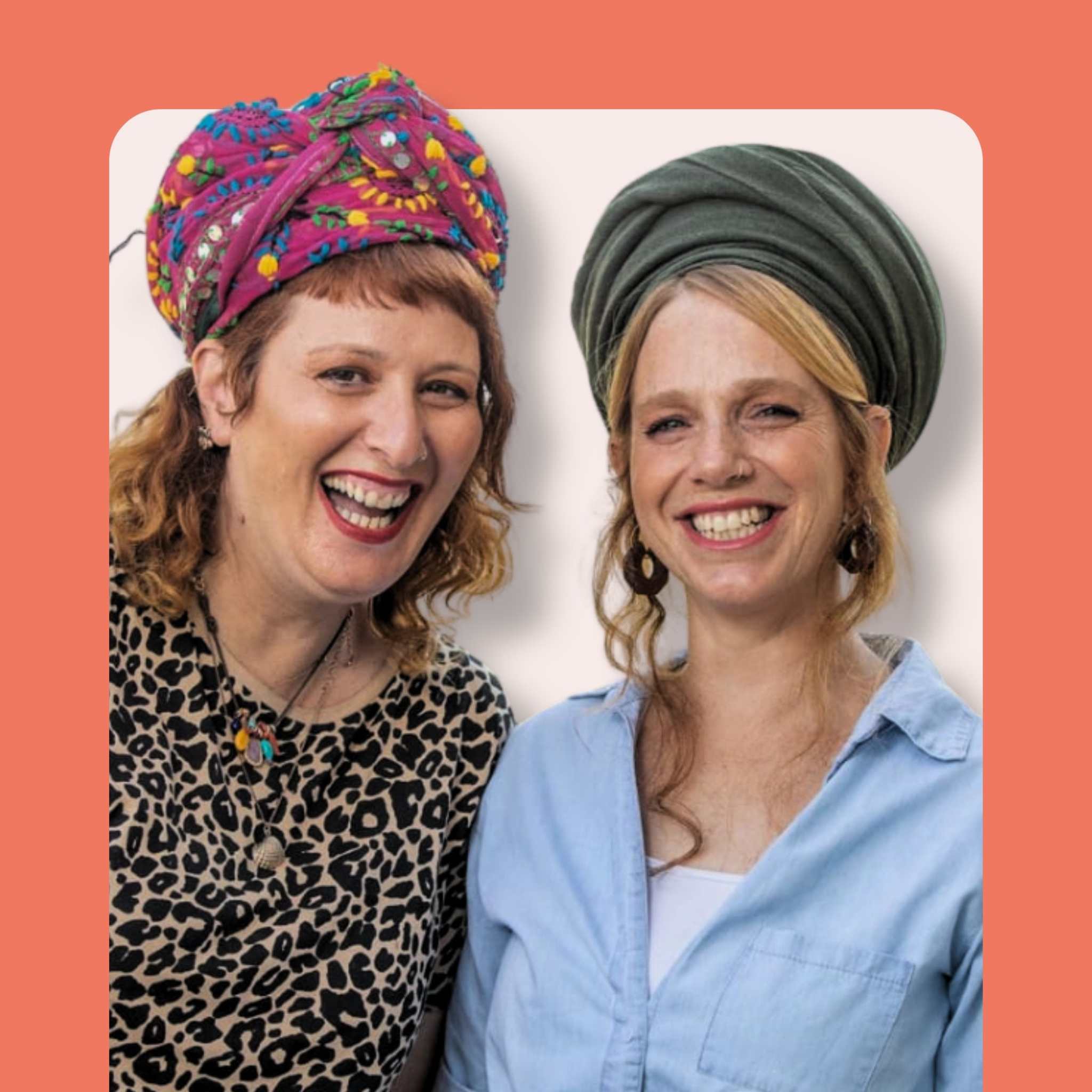 Two smiling women with headwraps, one in a colorful patterned turban and leopard print top, the other in a green headwrap and light blue shirt, standing in front of a peach background.