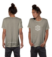 Nova Heaven T-Shirt in muted beige, with a small white geometric triangle emblem on the chest and text near the back hem.
