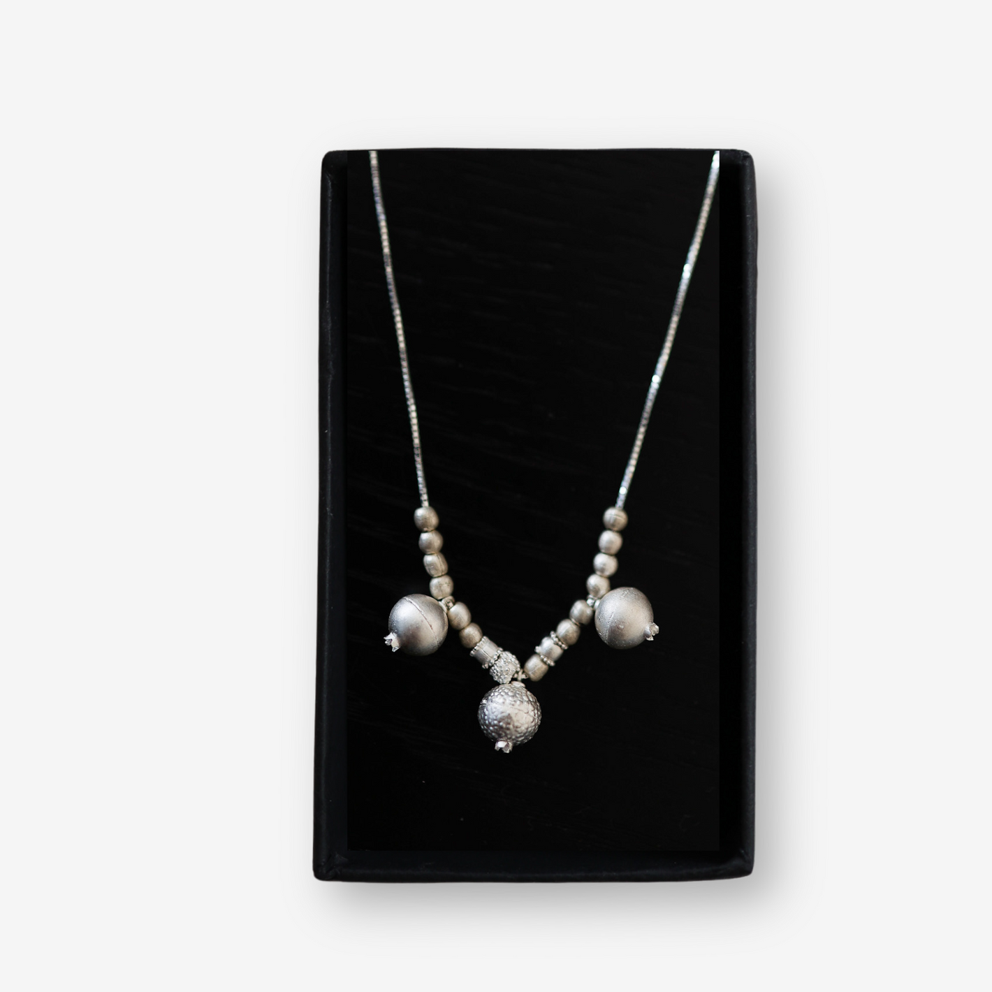 Handmade silver pomegranate necklace symbolizing Jewish heritage and abundance by Mique Jewelry