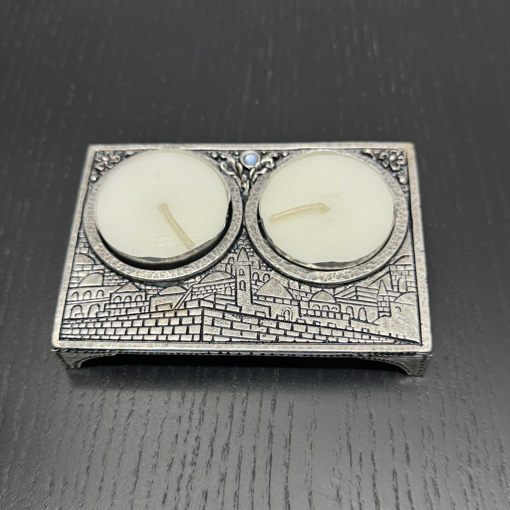 Silver-plated Jerusalem inspired travel candle holder with embossed motif and blue stone centerpiece for Shabbat lighting
