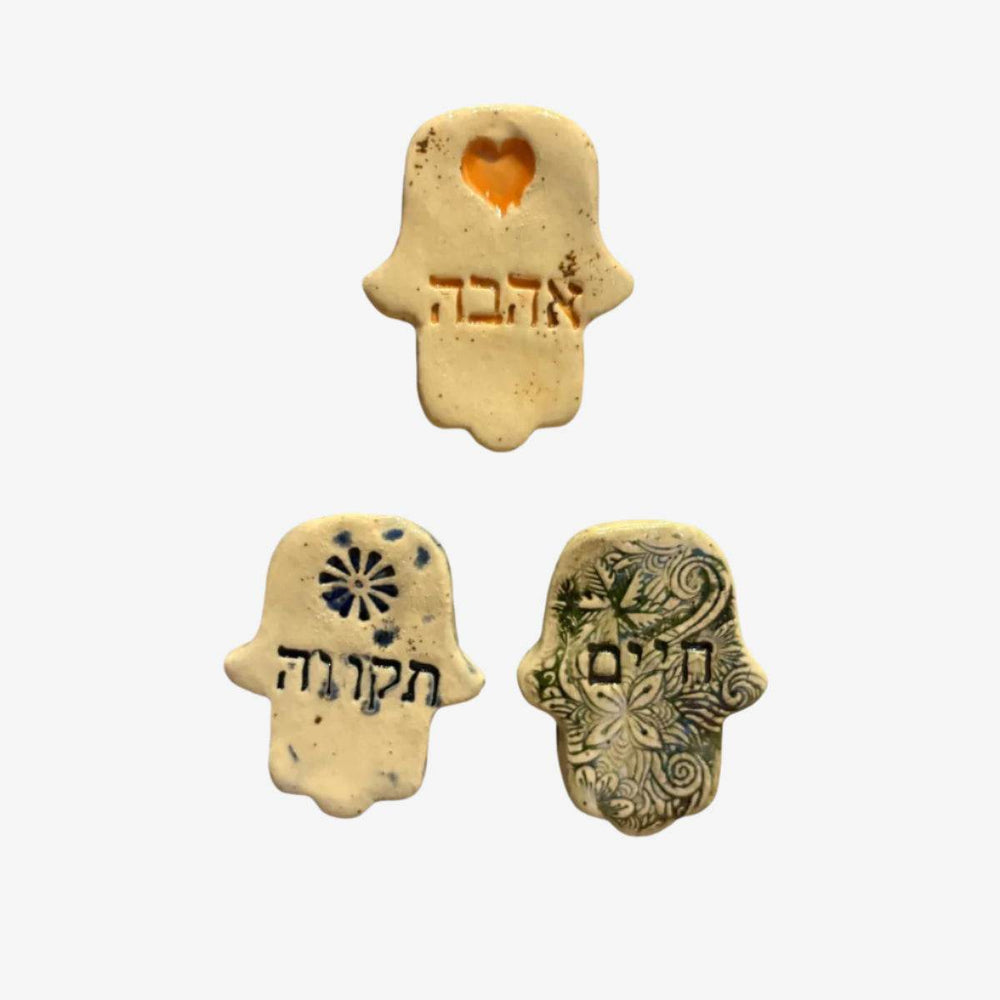 Handmade Israel ceramic heart and hamsa magnets symbolizing love and protection from Beit HaMelacha
