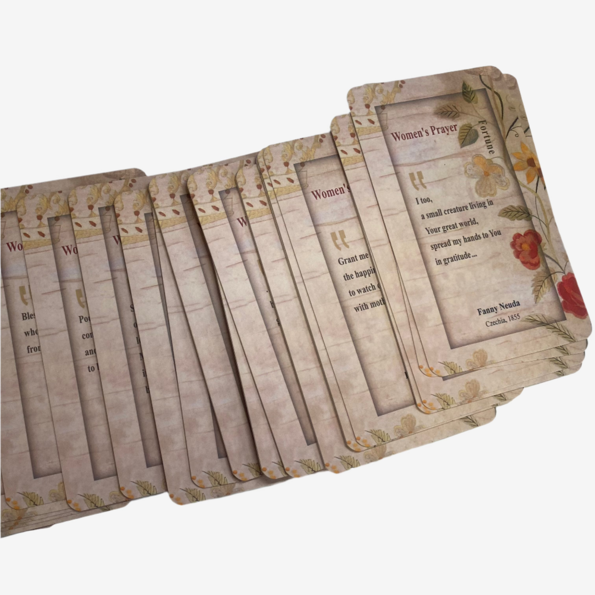 A spread of ESEK’s Tefilat Nashim: Women’s Prayer Cards by Dr. Aliza Lavie, with vintage floral borders and inspiring texts, lies on a white surface. The top card features a Jewish women’s prayer by Fanny Neuda.