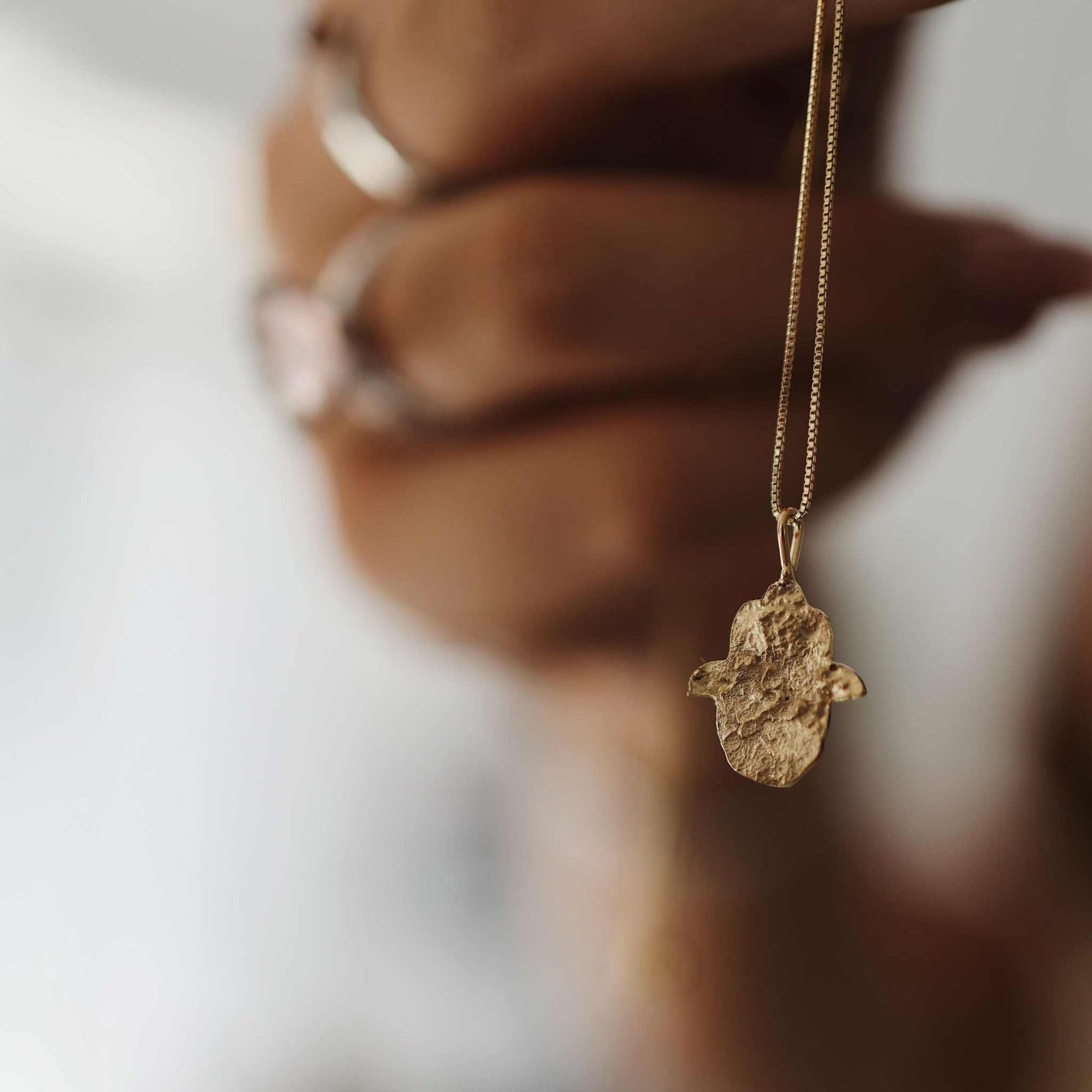 Gold Hamsa Necklace in 18k gold with Jerusalem stone texture crafted from 925 sterling silver
