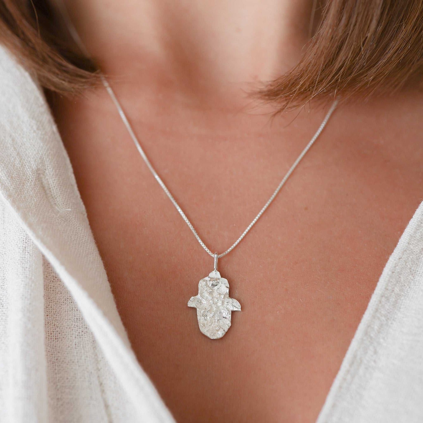 Sterling silver Hamsa necklace with textured Jerusalem stone finish by Sapir