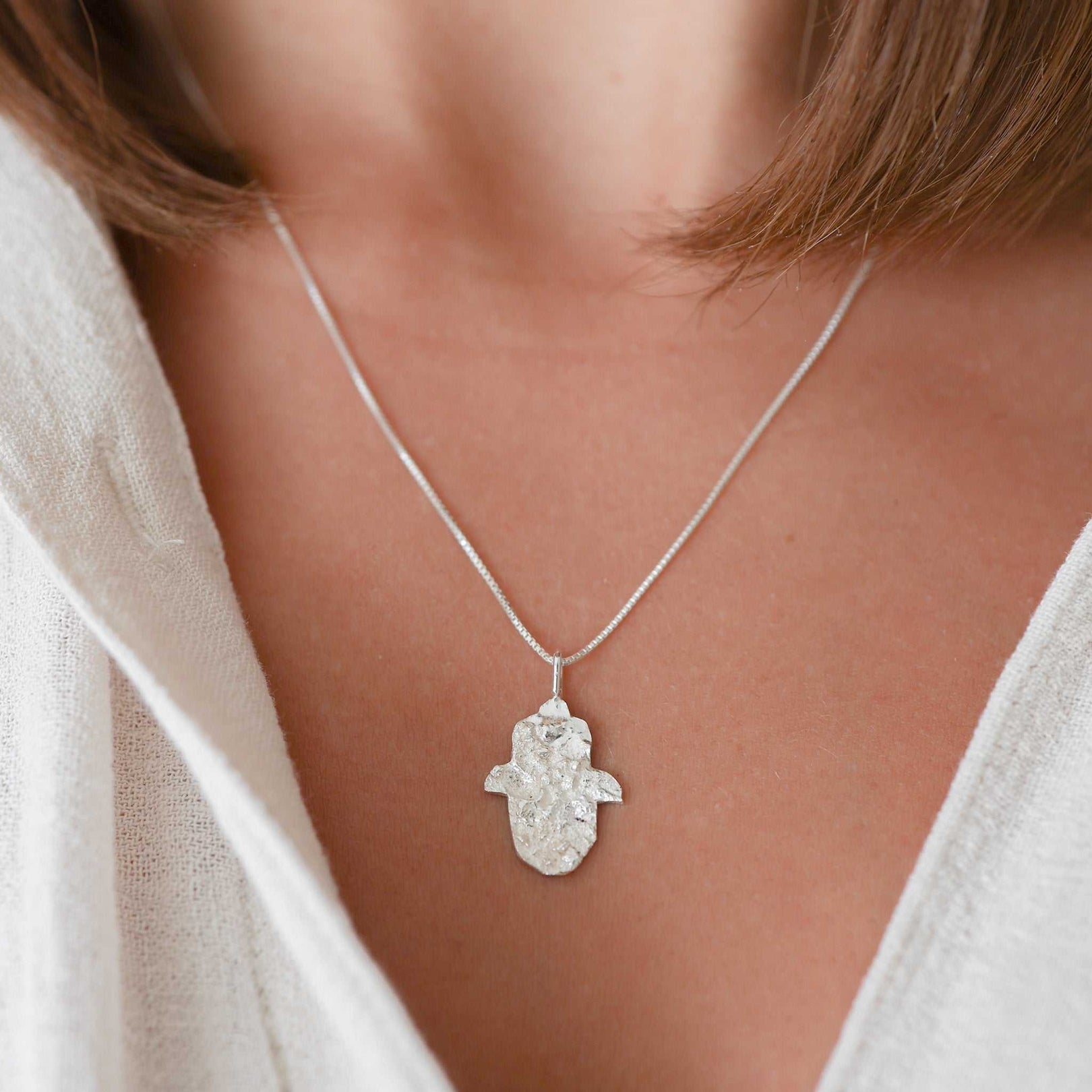 Sterling silver Hamsa necklace with textured Jerusalem stone finish by Sapir