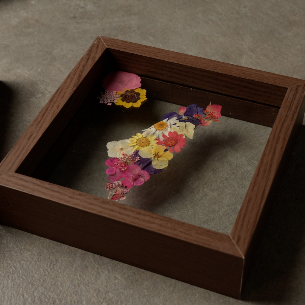 Pressed Flowers Framed Map of Israel with colorful dried flowers between glass in a dark natural wood frame