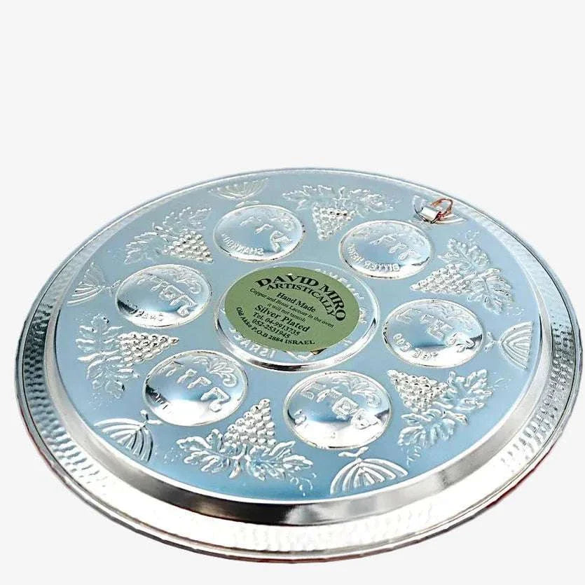 Handcrafted silver and copper Seder plate by David Miro showcasing traditional hammered craftsmanship for Passover.