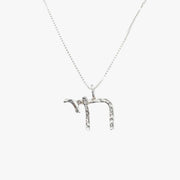Silver Chai pendant by Talya Harel in sterling silver on a delicate chain, symbolizing life with a refined design.