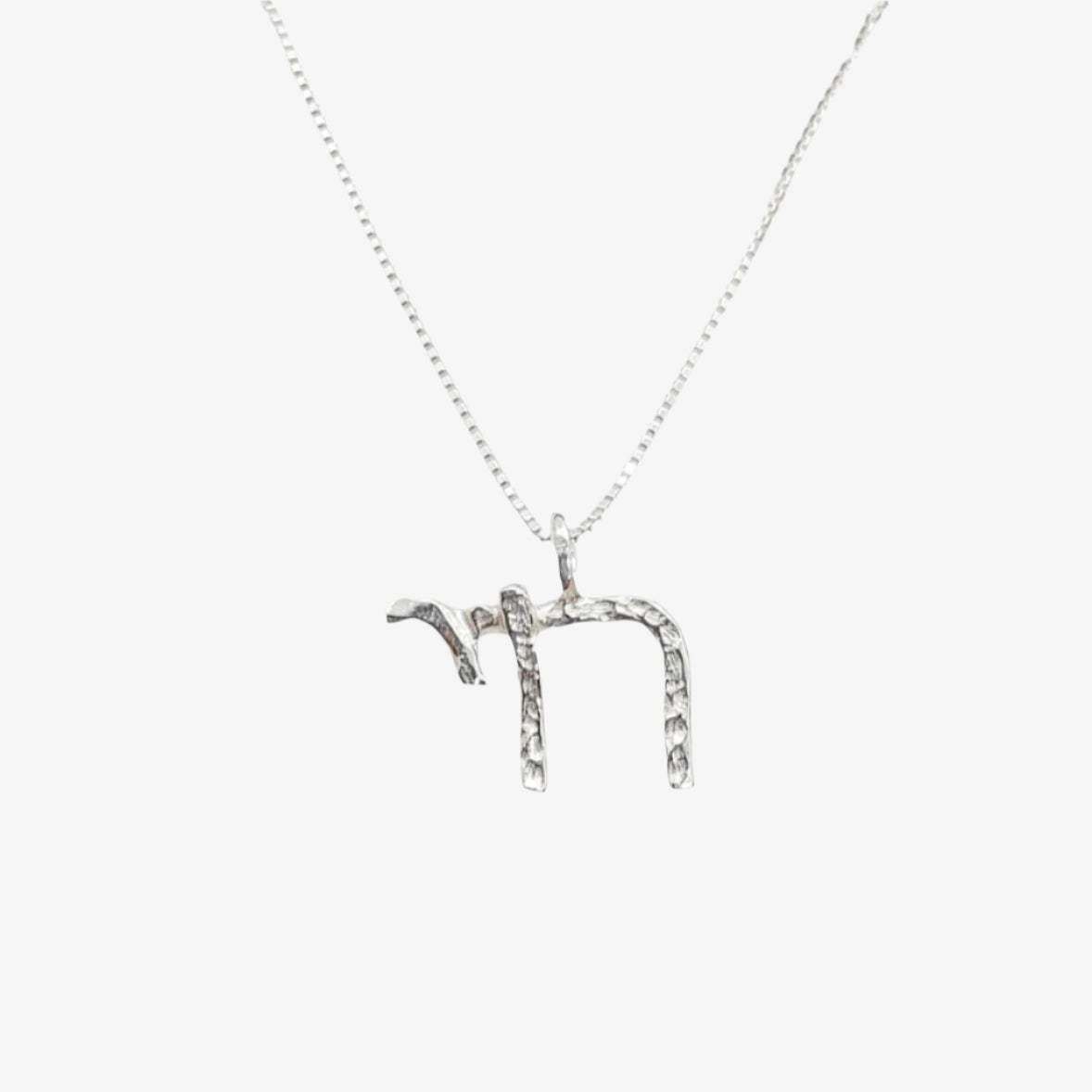 Silver Chai pendant by Talya Harel in sterling silver on a delicate chain, symbolizing life with a refined design.