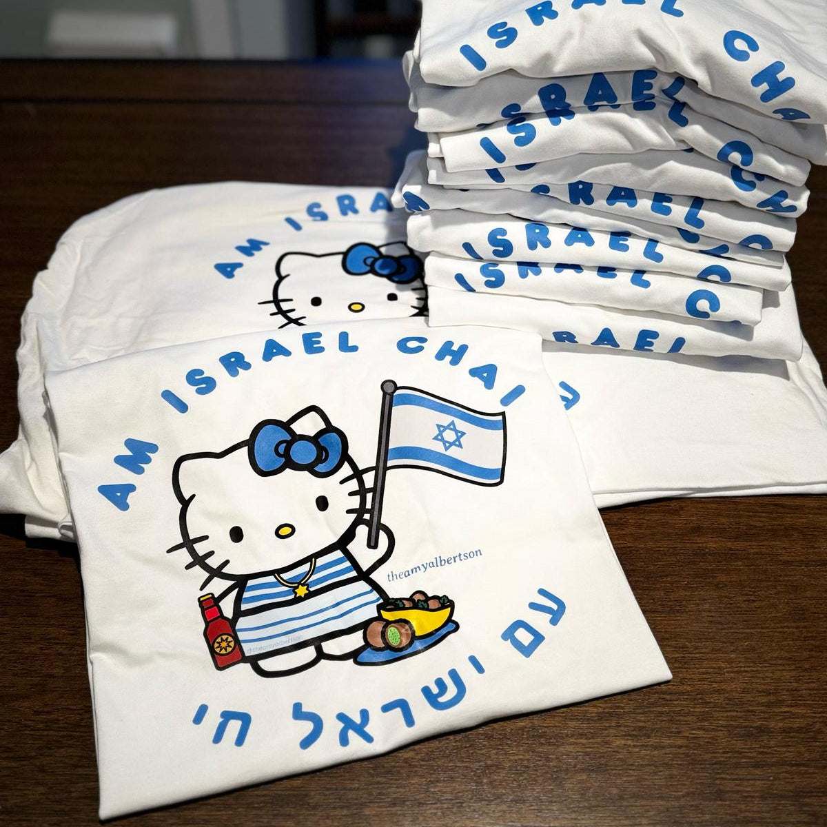 Am Israel Chai t-shirt featuring iconic kitty with Israeli flag and falafel.