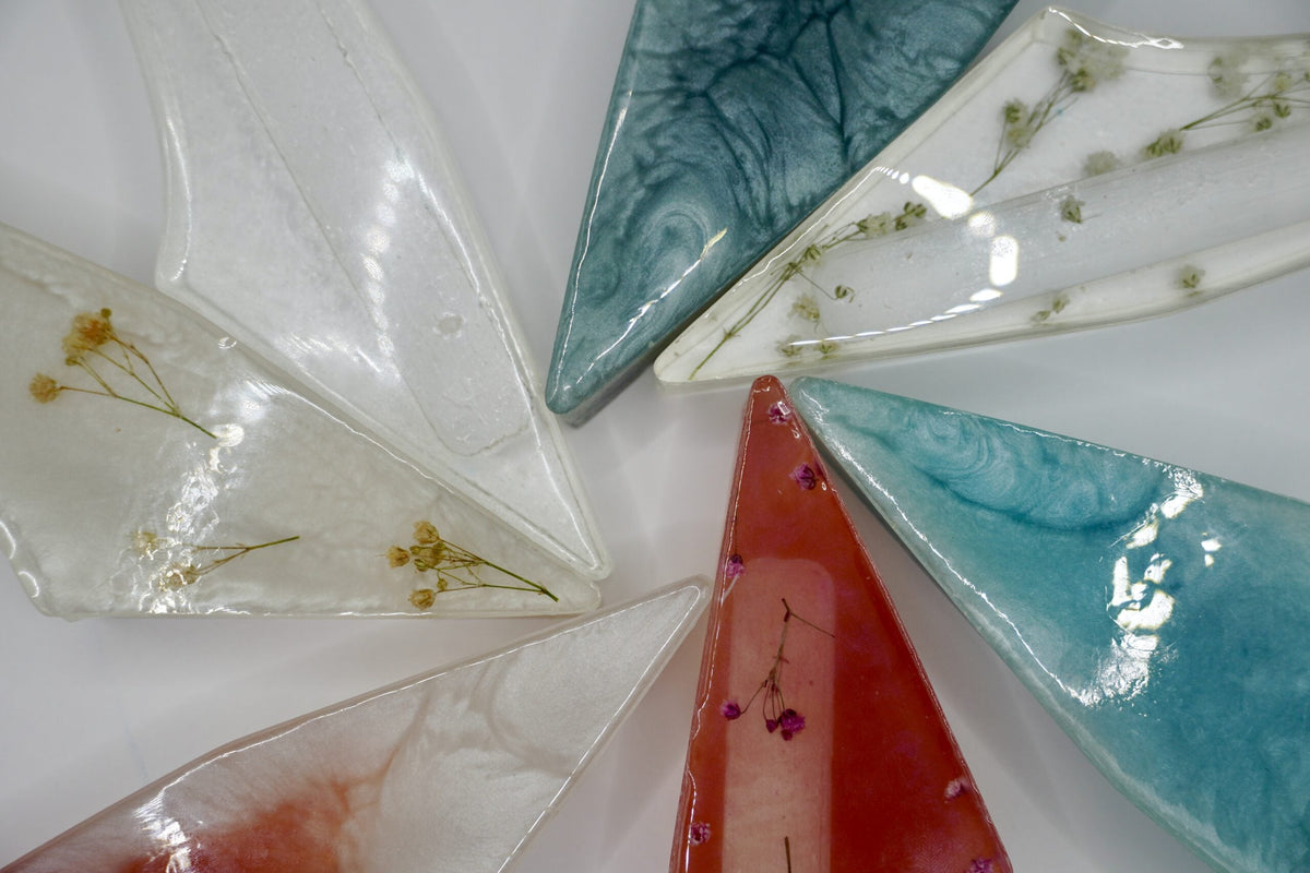 ADI Acrylic Mezuzah Case in translucent acrylic, with pointed triangular forms, marbled swirls and embedded botanical details in assorted colours.