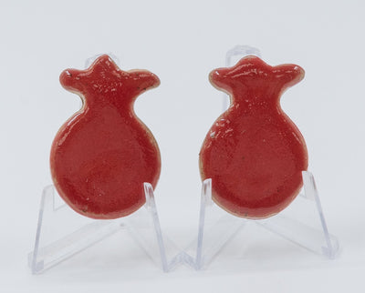 ADI Small Pomegranate Magnet, red glossy ceramic with a rounded fruit shape and crown-like top, shown as two examples.