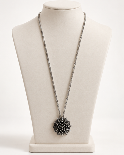 Nova Heaven Burning Man Necklace with a silver-tone chain and geometric black-and-silver sunburst pendant.