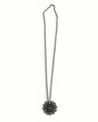 Nova Heaven Burning Man Necklace with a silver-tone chain and geometric spiked sunburst pendant in a layered design.