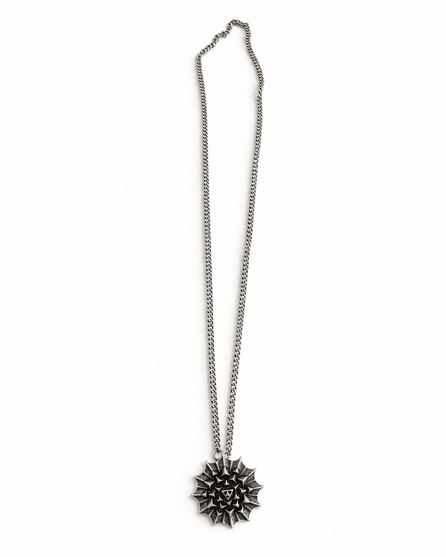 Nova Heaven Burning Man Necklace with a silver-tone chain and geometric spiked sunburst pendant in a layered design.