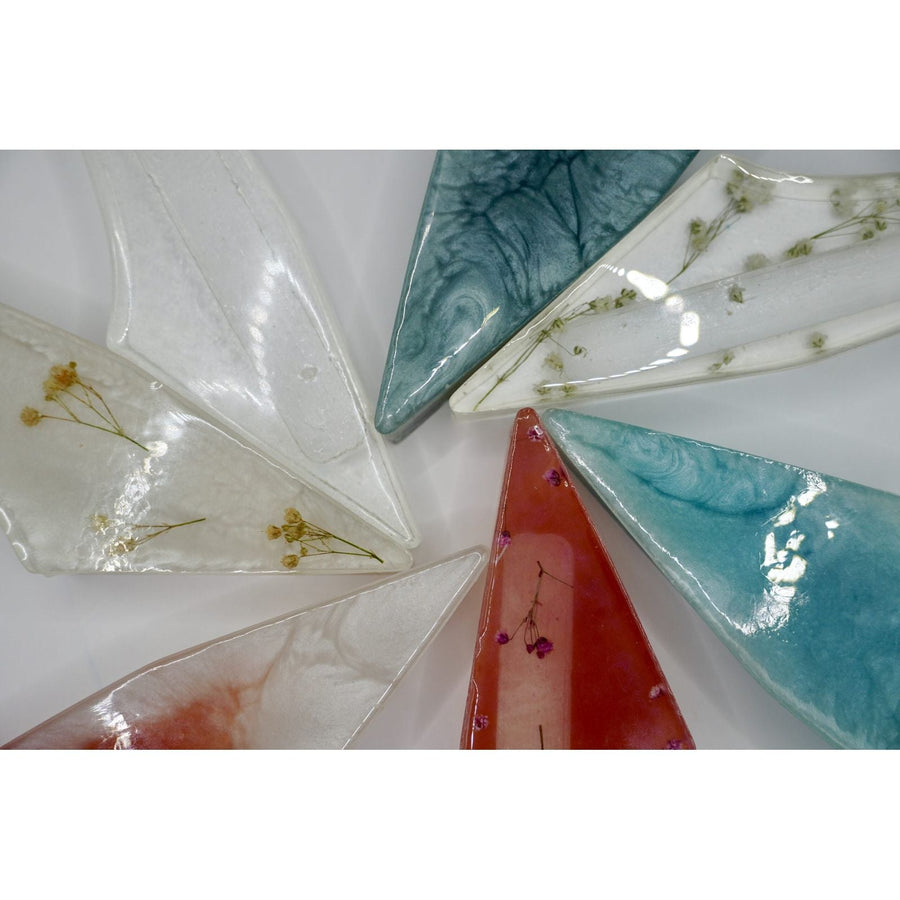 ADI Acrylic Mezuzah Case, translucent acrylic with pointed ends, marbled teal and red hues, and delicate dried botanical inclusions.