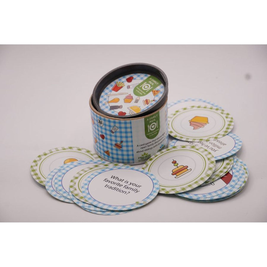 ADI A Family Meal Card Game in a blue gingham tin with round illustrated cards featuring colorful food and family prompts.