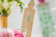 Light Up! Family Conversation Game with a kraft-brown candle-shaped card, printed with small turquoise text and a flame tip.