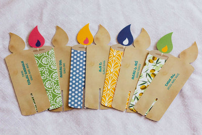 Light Up! Family Conversation Game with kraft paper candle-shaped cards, colorful patterned panels and flame-shaped tops.