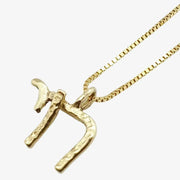 14K gold-plated Chai pendant on a fine gold chain, symbolizing life and elegance.