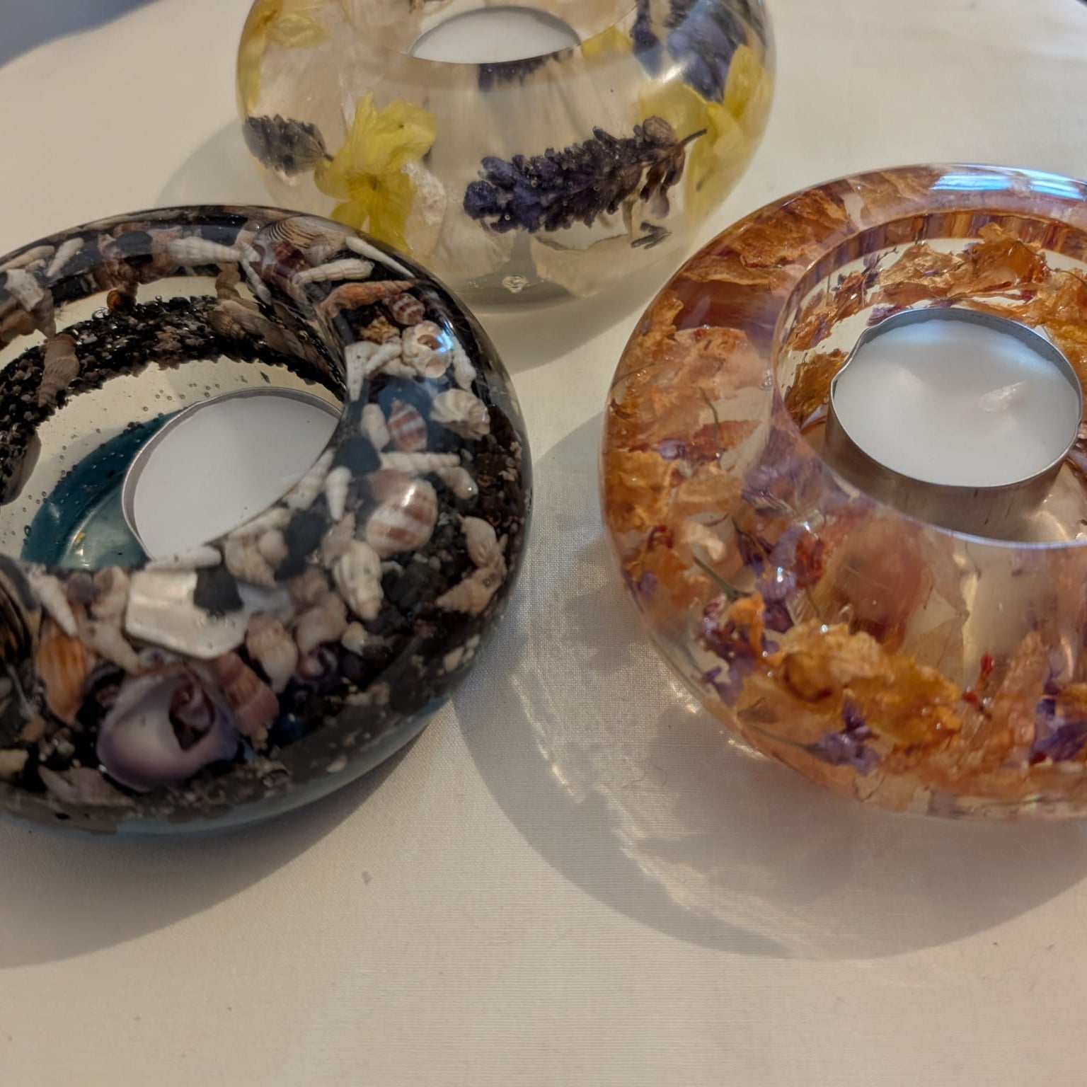 Handmade Israeli dried flowers candle holder in clear epoxy resin by Epoxy Lady, featuring natural flower glow