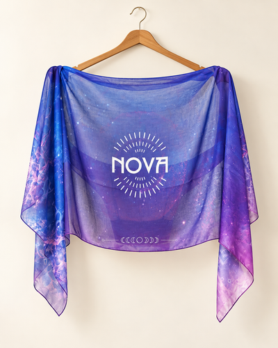 Nova Shawl — Purple, a sheer purple-blue cotton wrap with a cosmic pattern and centered white NOVA logo