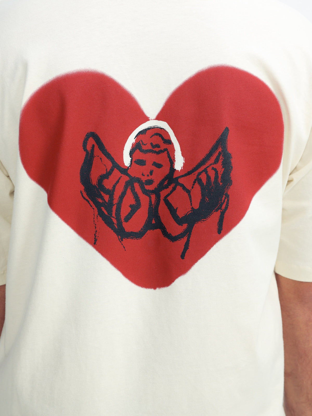 Omer Wenkert Heart T-Shirt in off-white cotton, with a large red heart and black angel illustration on the front.