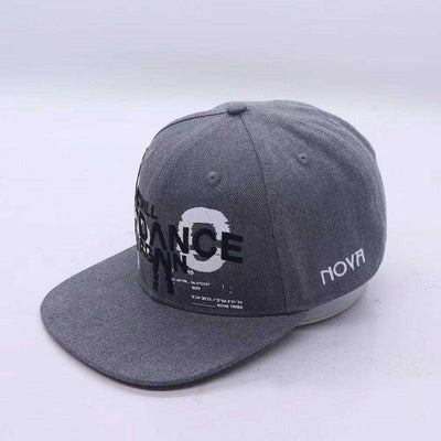 Grey snapback cap in textured fabric, featuring bold Nova We Will Dance Again lettering and a white Nova logo.